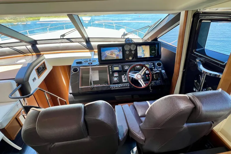  Yacht Photos Pics Luxurious helm of 2010 Princess V78 yacht with advanced navigation systems and leather seating.