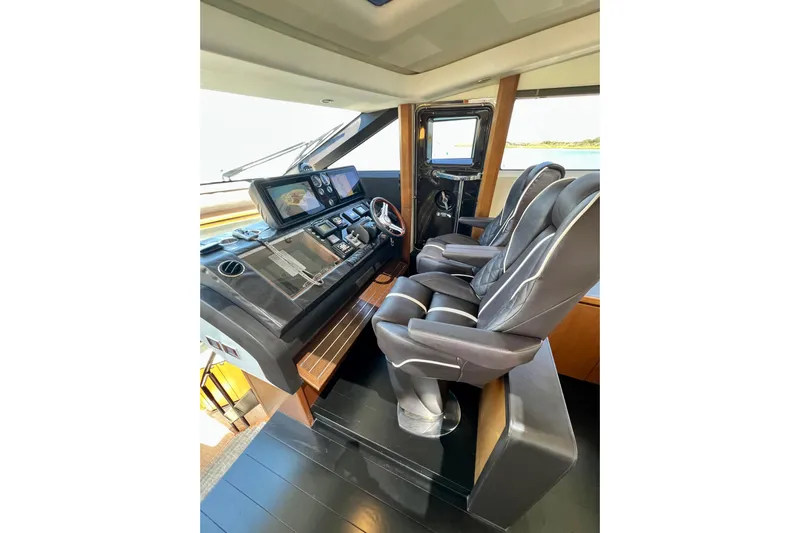  Yacht Photos Pics Luxury helm station of 2010 Princess V78 yacht with modern controls and leather seating.