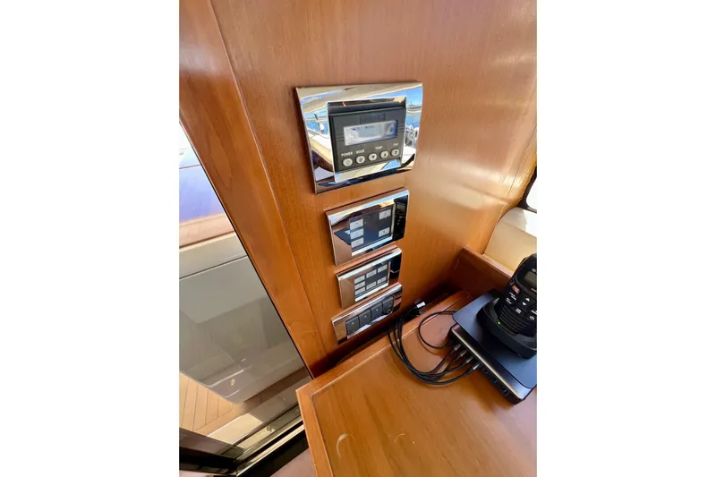  Yacht Photos Pics Control panel on 2010 Princess V78 yacht with electronic devices and wooden finish.