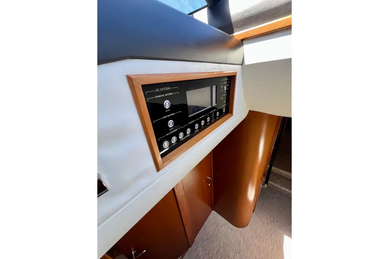  Yacht Photos Pics Control panel inside 2010 Princess V78 yacht, featuring wood accents and modern design.