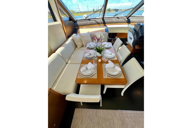  Yacht Photos Pics Luxurious dining area on 2010 Princess V78 yacht, elegantly set with white tableware.
