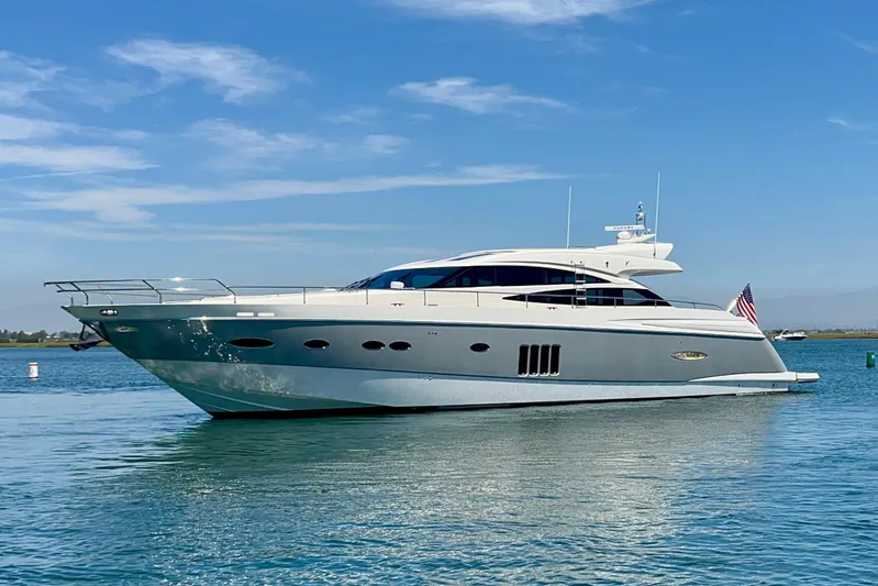  Yacht Photos Pics Luxurious 2010 Princess V78 yacht cruising on calm waters under a clear blue sky.