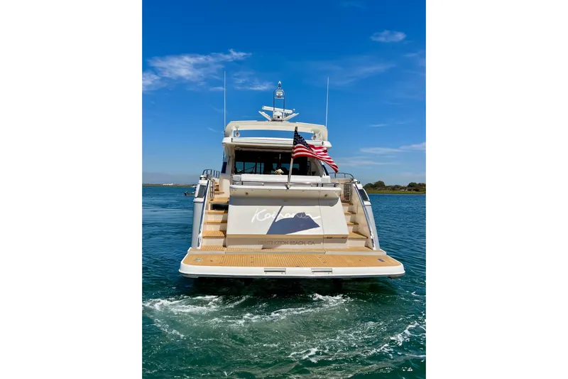  Yacht Photos Pics 2010 Princess V78 yacht on water, rear view with American flag, clear blue sky.