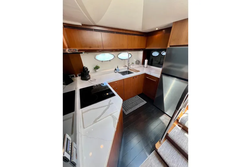  Yacht Photos Pics Luxurious kitchen interior of 2010 Princess V78 yacht with modern appliances and wood cabinetry.
