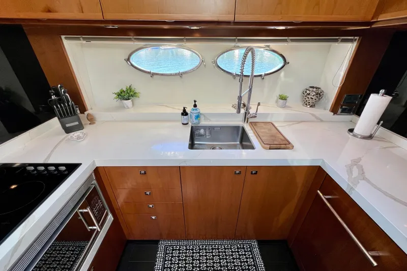  Yacht Photos Pics Luxurious kitchen in 2010 Princess V78 yacht with modern fixtures and elegant wood cabinetry.