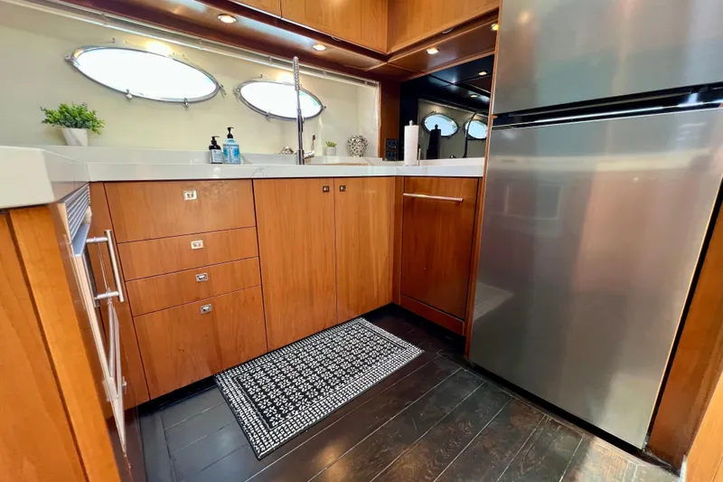  Yacht Photos Pics Luxurious kitchen interior of 2010 Princess V78 yacht with modern appliances and wood cabinetry.