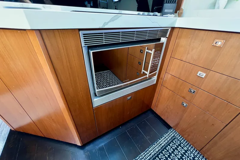  Yacht Photos Pics Wooden kitchen cabinetry with built-in microwave on a 2010 Princess V78 yacht.