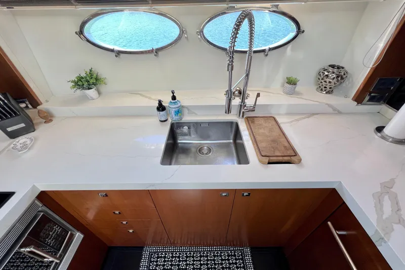  Yacht Photos Pics Luxurious kitchen interior of 2010 Princess V78 yacht with modern sink and elegant decor.