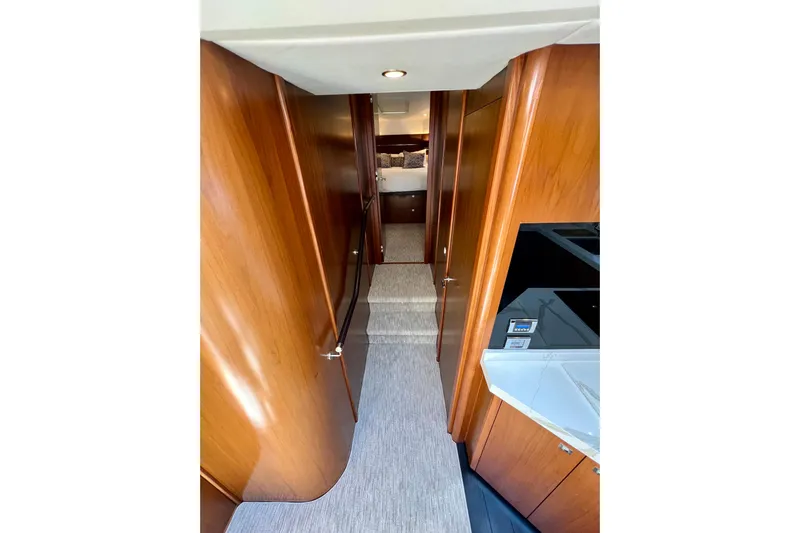  Yacht Photos Pics Interior hallway of 2010 Princess V78 yacht with wooden paneling and modern design.