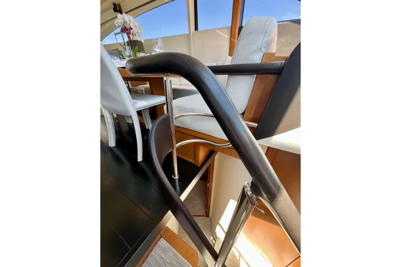  Yacht Photos Pics Interior of 2010 Princess V78 yacht, featuring elegant dining area and modern staircase.