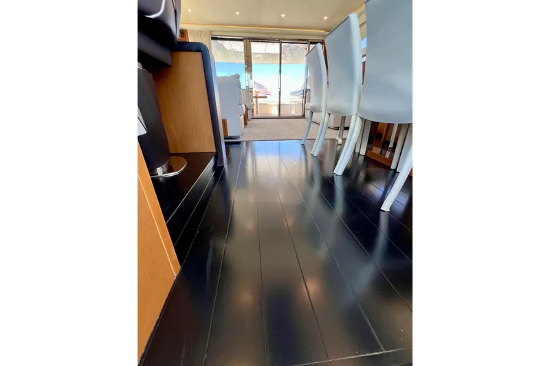  Yacht Photos Pics Luxurious interior of 2010 Princess V78 yacht with sleek black flooring and elegant seating.