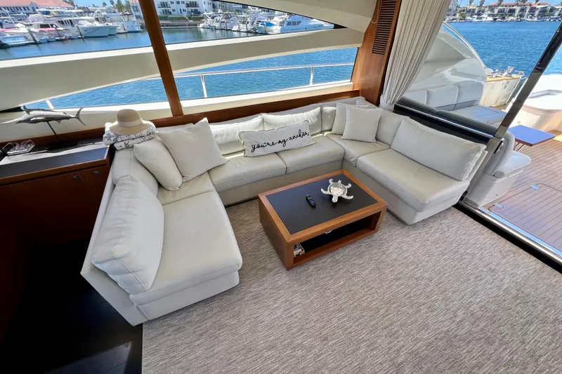  Yacht Photos Pics Luxurious interior of 2010 Princess V78 yacht with elegant white seating and scenic marina view.