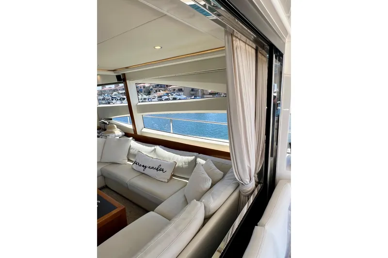  Yacht Photos Pics Luxurious interior of 2010 Princess V78 yacht with white seating and marina view.