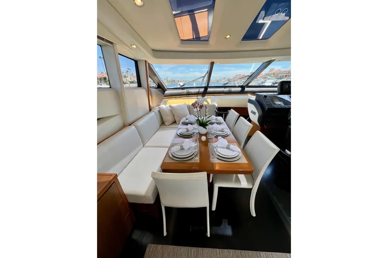  Yacht Photos Pics Luxurious dining area inside 2010 Princess V78 yacht, featuring elegant table setting and panoramic windows.