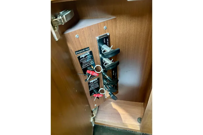  Yacht Photos Pics Control panel with switches and keys inside a wooden cabinet on a 2010 Princess V78 yacht.