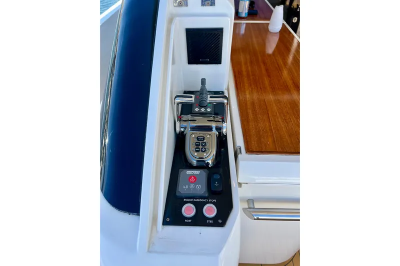  Yacht Photos Pics Control panel of a 2010 Princess V78 yacht with joystick and emergency stop buttons.