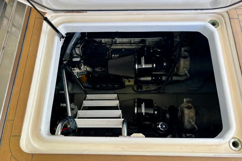  Yacht Photos Pics Engine compartment of a 2010 Princess V78 yacht, showcasing dual engines and access ladder.