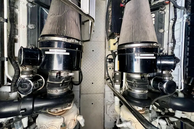  Yacht Photos Pics Engine room of 2010 Princess V78 yacht, showcasing dual air filters and mechanical components.