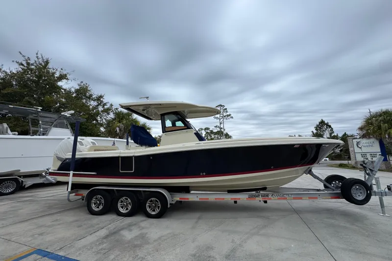  Yacht Photos Pics 2020 Chris-Craft Catalina 30 boat on trailer, parked outdoors under cloudy sky.