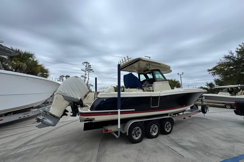  Yacht Photos Pics 2020 Chris-Craft Catalina 30 boat on trailer, parked outdoors under cloudy sky.