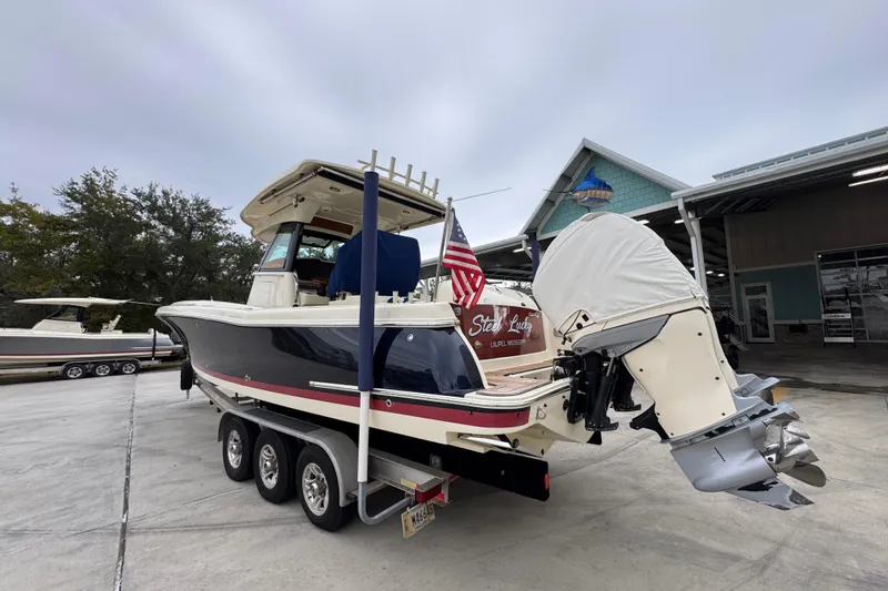  Yacht Photos Pics 2020 Chris-Craft Catalina 30 boat on trailer, parked outdoors with American flag.