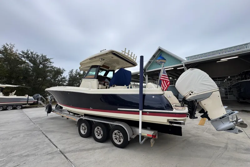  Yacht Photos Pics 2020 Chris-Craft Catalina 30 boat on trailer, parked outdoors with American flag.