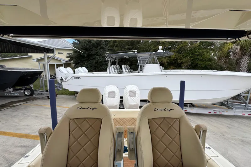  Yacht Photos Pics 2020 Chris-Craft Catalina 30 boat with luxurious seating, parked outdoors.