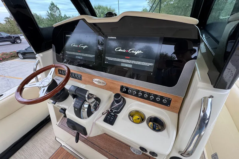  Yacht Photos Pics 2020 Chris-Craft Catalina 30 helm with dual Garmin displays and wooden steering wheel.