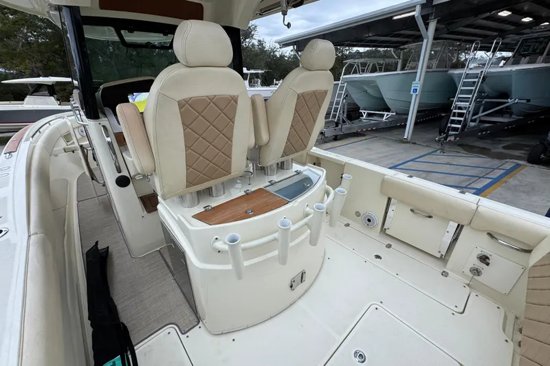  Yacht Photos Pics 2020 Chris-Craft Catalina 30 boat interior with beige seating and fishing rod holders.