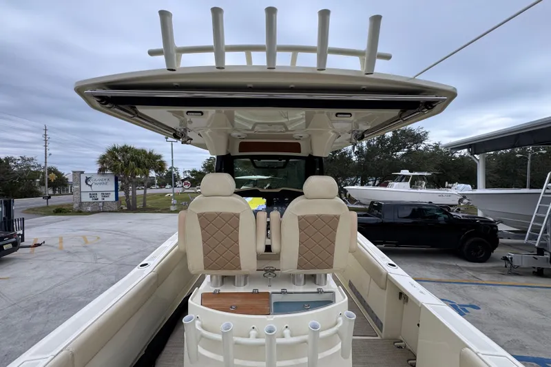  Yacht Photos Pics 2020 Chris-Craft Catalina 30 boat interior with seating and rod holders, parked outdoors.