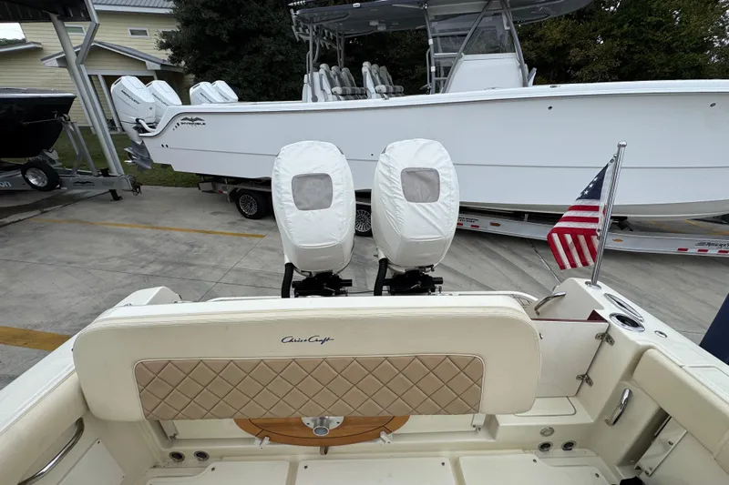  Yacht Photos Pics 2020 Chris-Craft Catalina 30 boat with covered engines and American flag, docked outdoors.