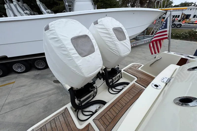  Yacht Photos Pics 2020 Chris-Craft Catalina 30 with covered outboard motors and American flag on deck.