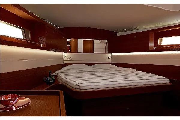 Secret Location Yacht Photos Pics Luxurious cabin interior of 2014 Beneteau Oceanis 45 yacht with cozy bed and wooden finish.