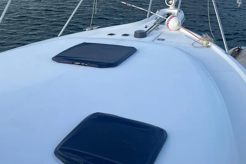  Yacht Photos Pics 2003 Tiara Yachts 3100 Open deck with hatches, on calm water.