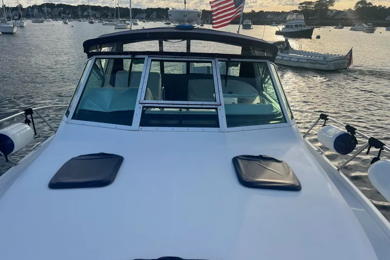  Yacht Photos Pics 2003 Tiara Yachts 3100 Open boat docked in a scenic harbor.