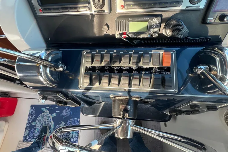  Yacht Photos Pics Control panel of a 2003 Tiara Yachts 3100 Open, featuring switches and navigation equipment.