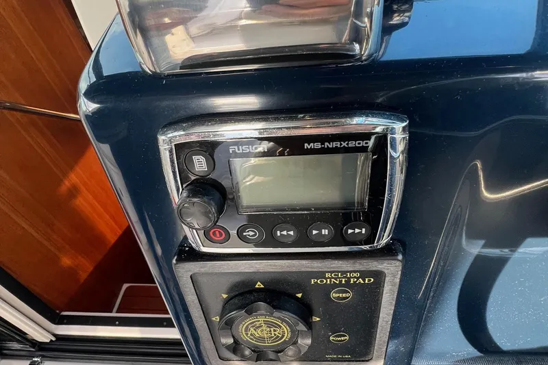  Yacht Photos Pics Control panel of a 2003 Tiara Yachts 3100 Open, featuring Fusion MS-NRX200 and RCL-100 Point Pad.