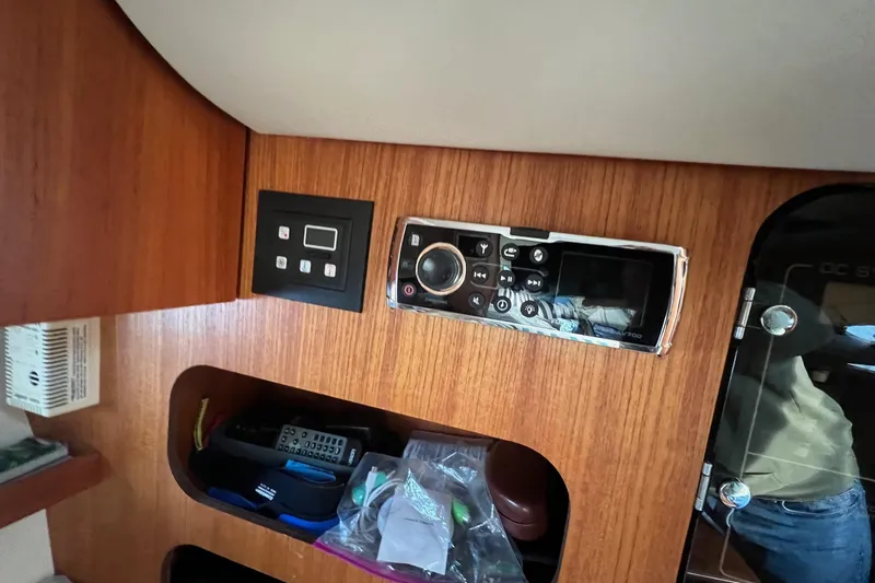  Yacht Photos Pics 2003 Tiara Yachts 3100 Open cabin interior with control panel and storage.