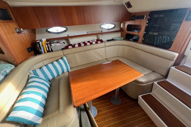  Yacht Photos Pics Luxurious interior of 2003 Tiara Yachts 3100 Open with cozy seating and wooden table.