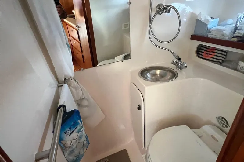  Yacht Photos Pics 2003 Tiara Yachts 3100 Open bathroom with sink, shower, and storage.