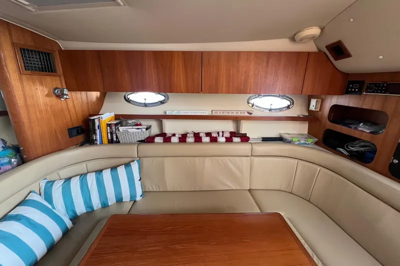  Yacht Photos Pics 2003 Tiara Yachts 3100 Open cabin interior with beige seating and wooden accents.