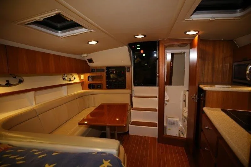  Yacht Photos Pics Interior of 2003 Tiara Yachts 3100 Open, featuring cozy seating and wooden finishes.