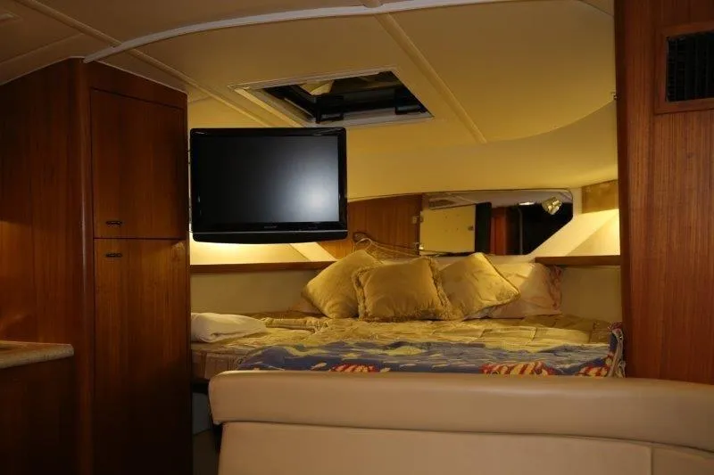  Yacht Photos Pics Interior of 2003 Tiara Yachts 3100 Open, featuring cozy bed and mounted TV.
