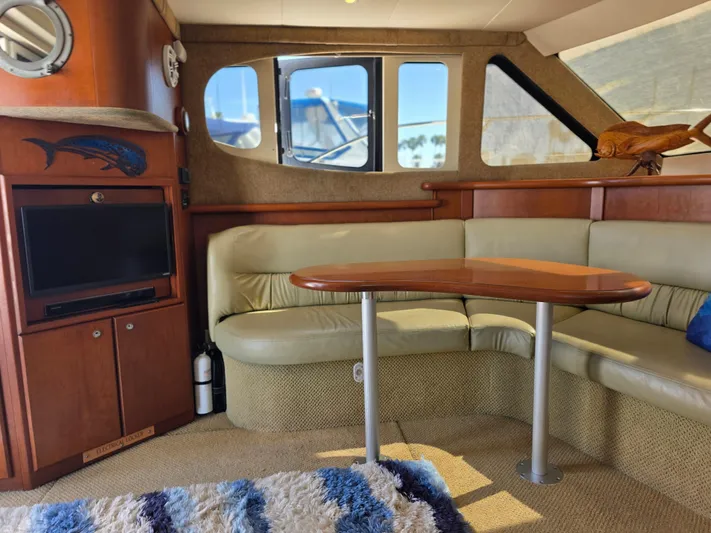 Sanctuary Yacht Photos Pics Interior of 2006 Silverton 36 Convertible yacht with cozy seating and wooden accents.