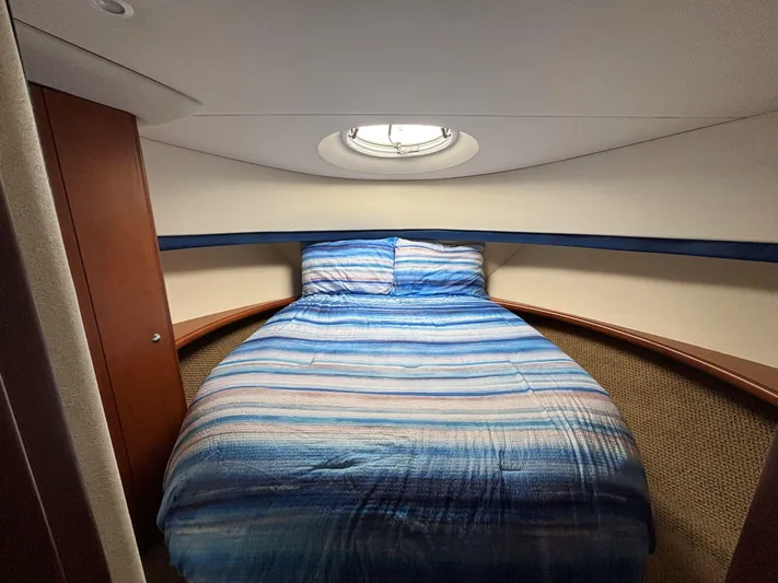 Sanctuary Yacht Photos Pics 2006 Silverton 36 Convertible cabin with a cozy bed and nautical decor.