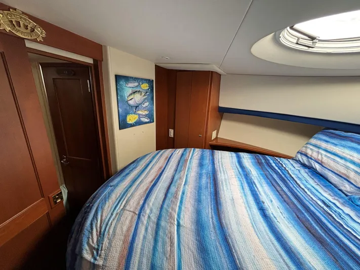Sanctuary Yacht Photos Pics Interior of 2006 Silverton 36 Convertible boat with striped bedding and wall art.