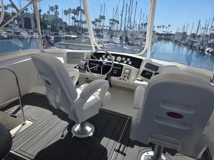 Sanctuary Yacht Photos Pics 2006 Silverton 36 Convertible yacht cockpit with dual seats and marina view.