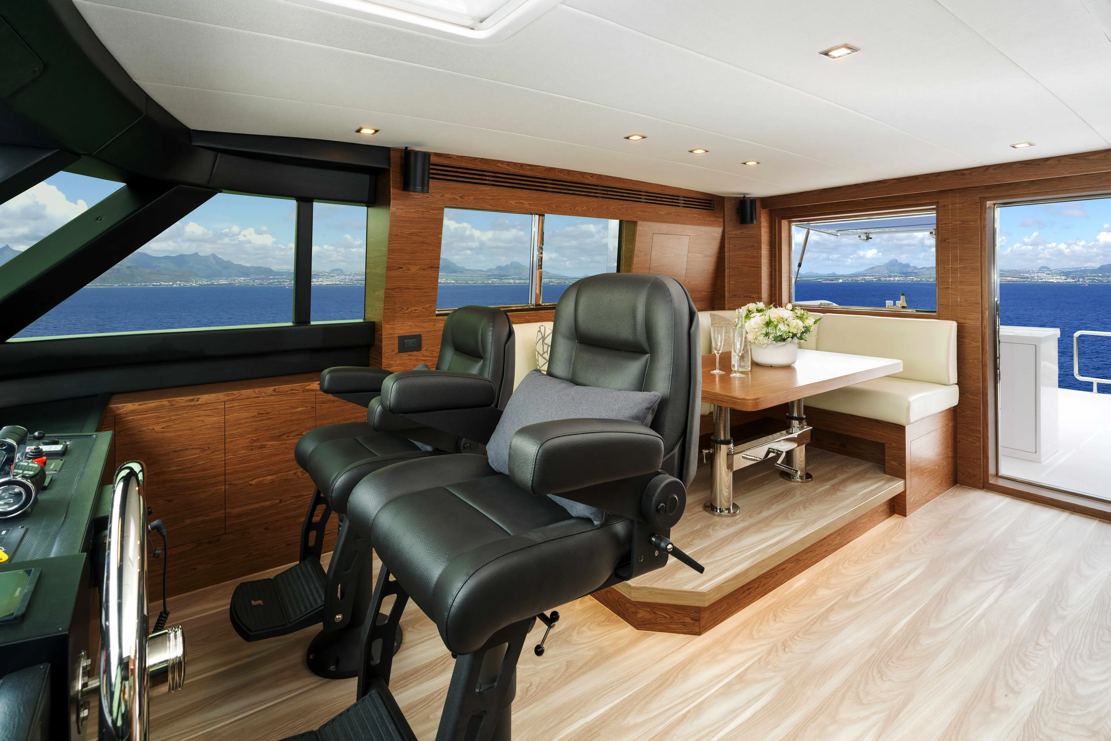 V77s-613 / Available Spring 2026 Yacht Photos Pics Luxurious interior of 2026 Horizon V77S yacht with leather seating and ocean view.