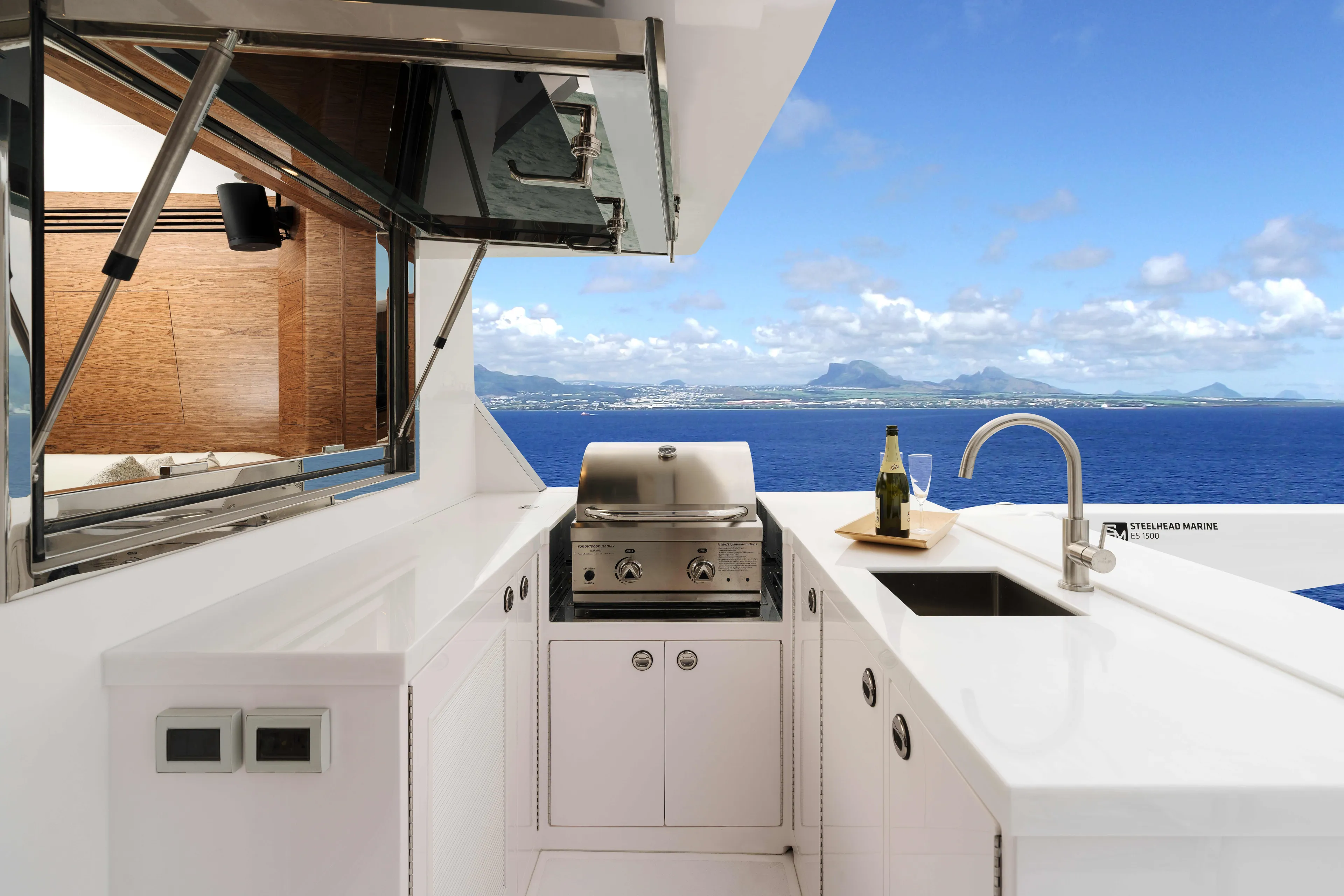 V77s-613 / Available Spring 2026 Yacht Photos Pics Luxurious Horizon V77S yacht kitchen with ocean view, featuring grill and sink, 2026 model.