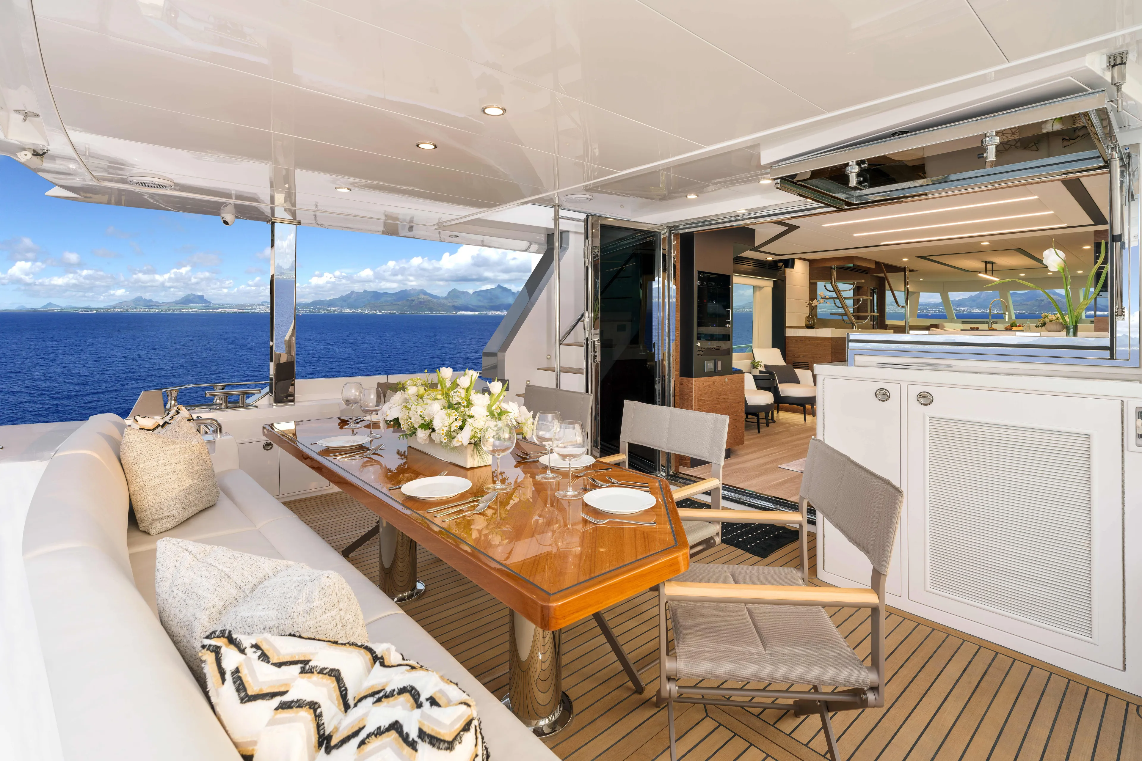 V77s-613 / Available Spring 2026 Yacht Photos Pics Luxurious Horizon V77S yacht deck with elegant dining setup, ocean view, and modern interior, 2026 model.
